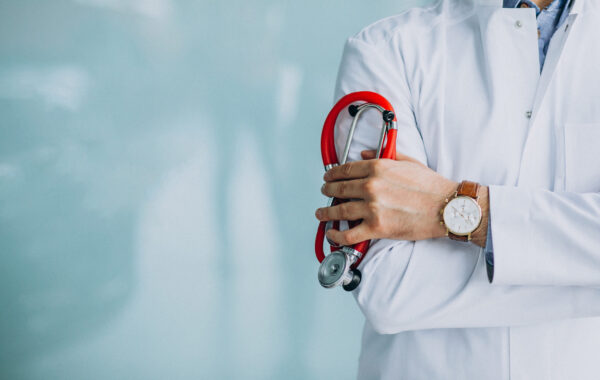 Young handsome physician in a medical robe with stethoscope